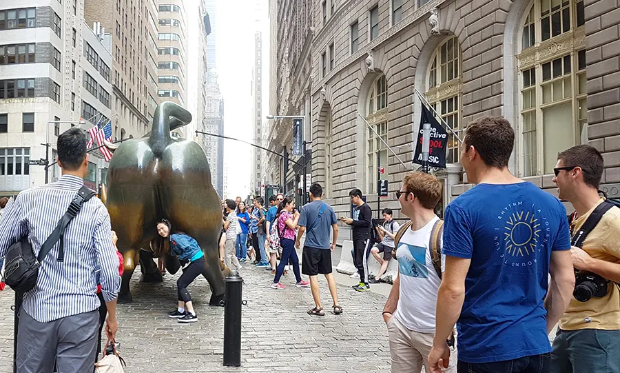 Tourists touching the rear end and private parts of the Wall Street Bull statue - Photo by Andrea Hoare Madrid