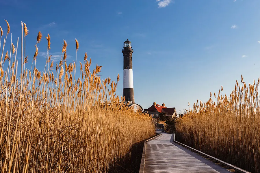 Fire Island lighthouse in the Hamptons, a road trip near New York. Photo by Julian Bracero on Unsplash, available at https://unsplash.com/photos/T7bhrAEzF-I