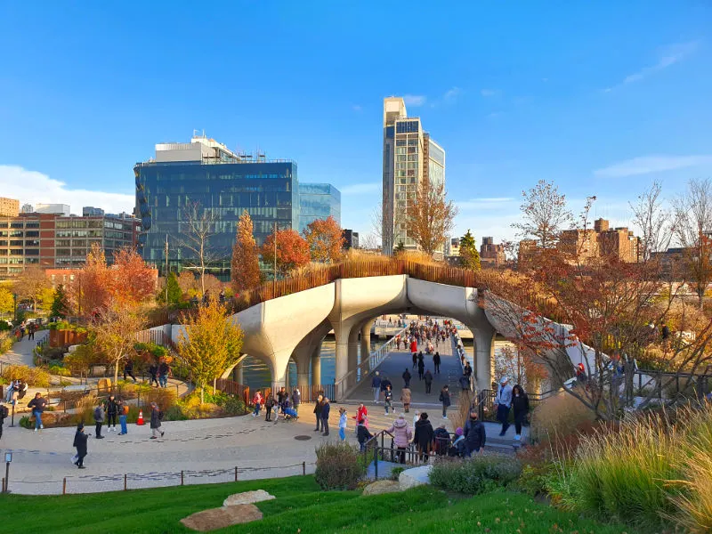 People strolling through Little Island, with the Hudson River and Chelsea in the background. Photo by Andrea Hoare Madrid