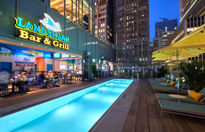 Poolside bar at the Margaritaville Resort Times Square in Midtown Manhattan. List of recommended hotels with pools. Photo courtesy of Booking