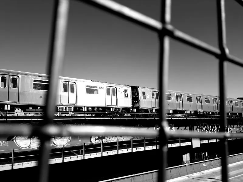 View of the train passing along the subway lane on the Williamsburg Bridge. Black and white photo by Andrea Hoare Madrid