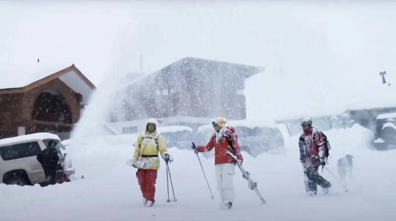 Esquiadores caminando por La Parva un día nevado - Captura de pantalla del video "Visit La Parva" https://www.youtube.com/watch?v=RwLg4cW0kQ0